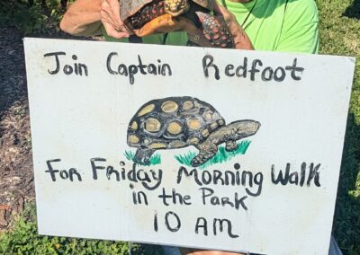 Lady holds up red-footed tortoise